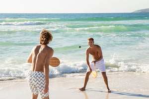 Playing Frescobol at the beach